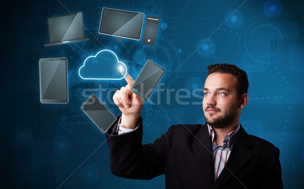 Attractive businessman touching high technlogy cloud service Stock photo © ra2studio