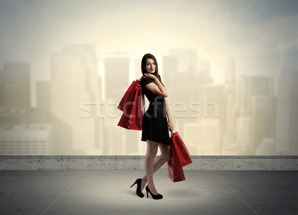 Stock photo: City woman standing with shopping bags