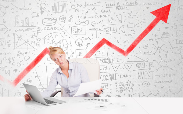 Business woman sitting at table with market diagrams  Stock photo © ra2studio
