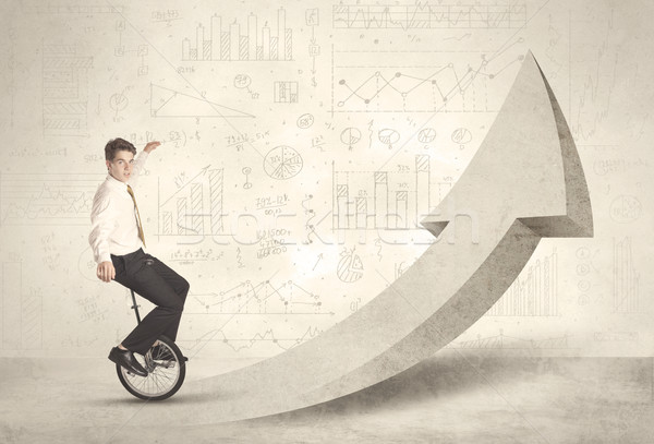 Happy business man riding a monocycle up on an arrow  Stock photo © ra2studio