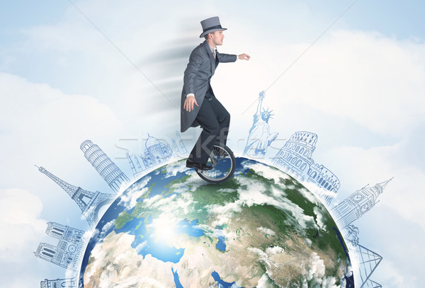 Man riding unicycle around the globe with major cities Stock photo © ra2studio