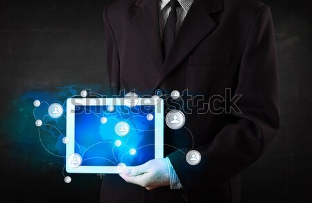 Young person holding talbet with communication technology concep Stock photo © ra2studio