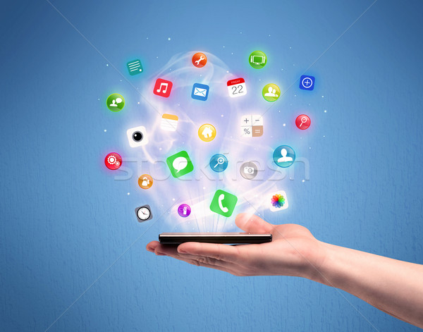 Hand holding tablet phone with app icons Stock photo © ra2studio