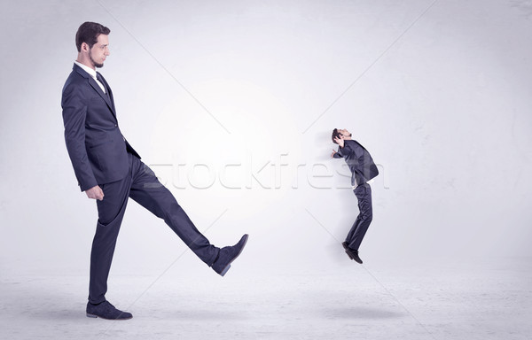 Big man kicking little himself out Stock photo © ra2studio