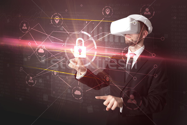 Man with VR goggles unlocking 3D network concept Stock photo © ra2studio