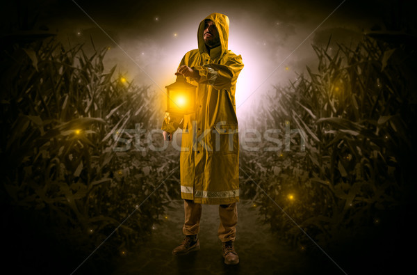 Man coming out from a thicket with lantern Stock photo © ra2studio