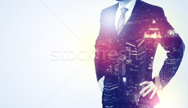 Young man thinking with city wallpaper Stock photo © ra2studio
