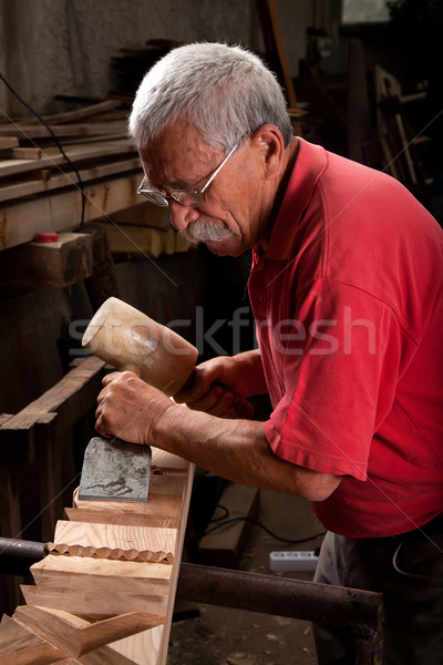 woodcarver working with mallet and chisel Stock photo © ra2studio
