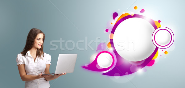 attractive young woman holding a laptop and presenting abstract speech bubble copy space Stock photo © ra2studio