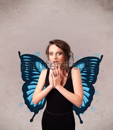Stock photo: Young girl with devil horns and wings drawing