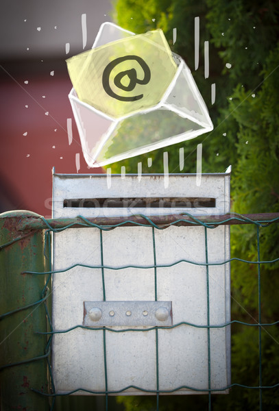 Stock photo: Envelope with email sign dropping into mailbox