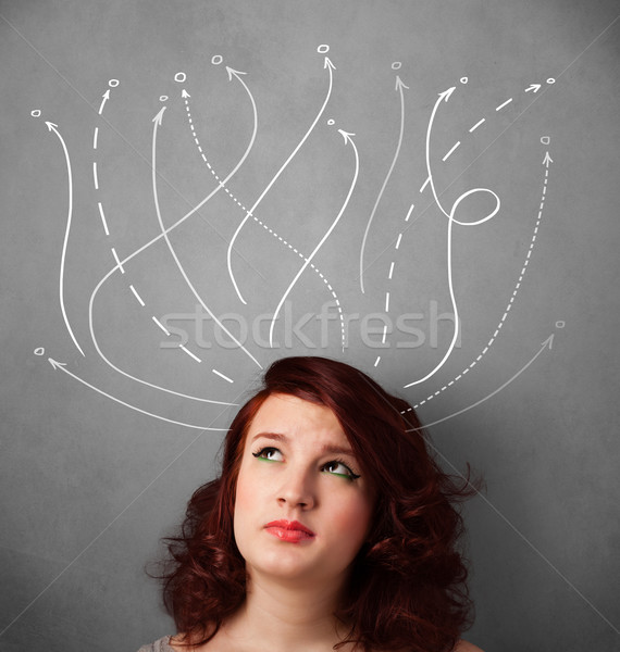 Young woman with arrows coming out of her head Stock photo © ra2studio