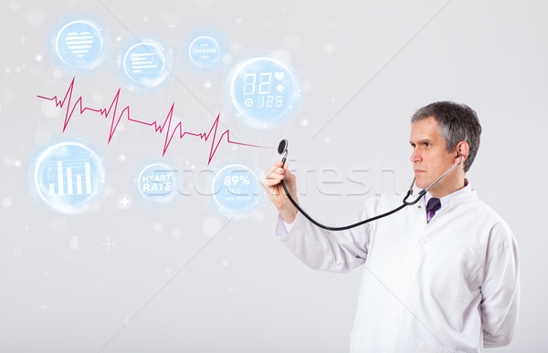 Doctor examinating modern heartbeat graphics Stock photo © ra2studio