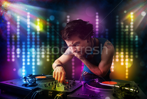 Dj playing songs in a disco with light show Stock photo © ra2studio