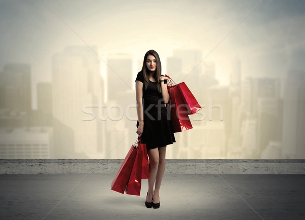 Stock photo: City woman standing with shopping bags