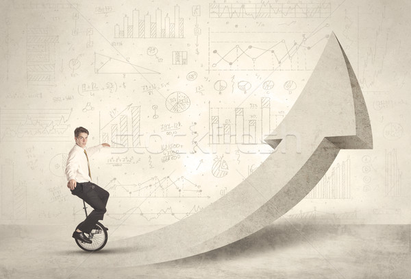 Happy business man riding a monocycle up on an arrow  Stock photo © ra2studio