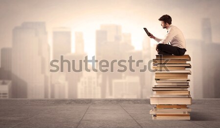 Homme au-dessus ville séance livres sérieux [[stock_photo]] © ra2studio