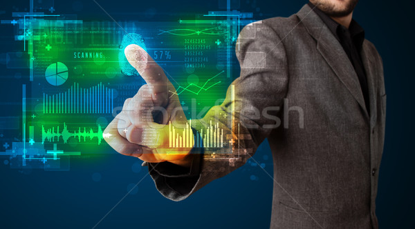 Young businessman pressing modern technology panel with finger p Stock photo © ra2studio