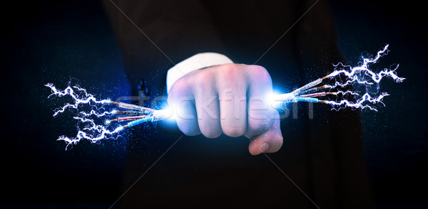 Stock photo: Business person holding electrical powered wires