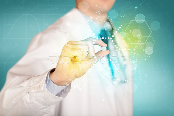 A doctor in tie holding a pill Stock photo © ra2studio