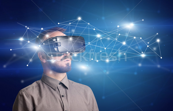 Businessman with virtual reality goggles Stock photo © ra2studio