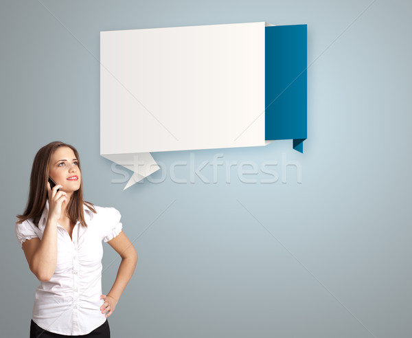 pretty young woman standing next to modern origami copy space and making phone call Stock photo © ra2studio