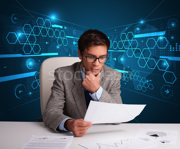 Stock photo: Businessman doing paperwork with futuristic backgroung