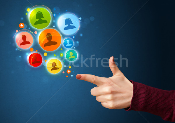 Social media icons coming out of gun shaped hand Stock photo © ra2studio