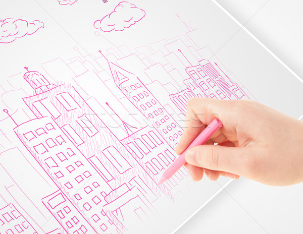 A person drawing sketch of a city with balloons and clouds on a plain paper Stock photo © ra2studio