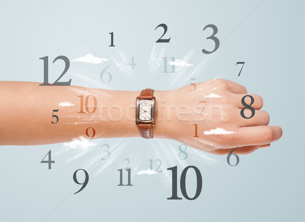 Hand with watch and numbers on the side comming out Stock photo © ra2studio