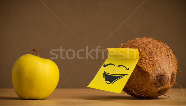 Coconut with post-it note laughing on apple Stock photo © ra2studio