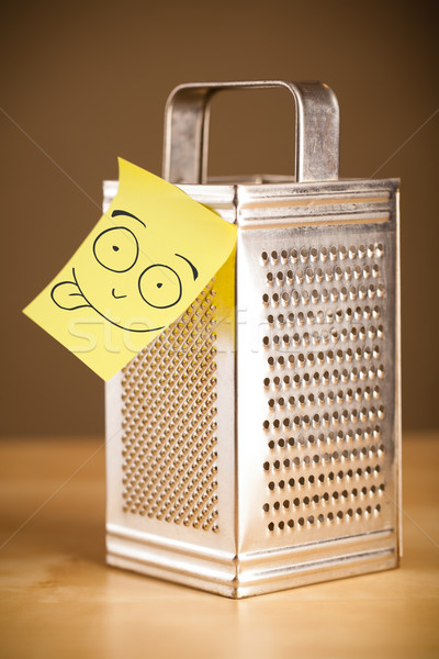 Post-it note with smiley face sticked on a grater Stock photo © ra2studio