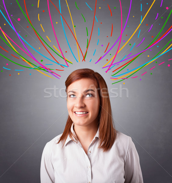 Young girl thinking with colorful abstract lines overhead Stock photo © ra2studio