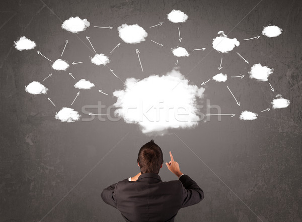 Businessman sitting with cloud technology above his head Stock photo © ra2studio