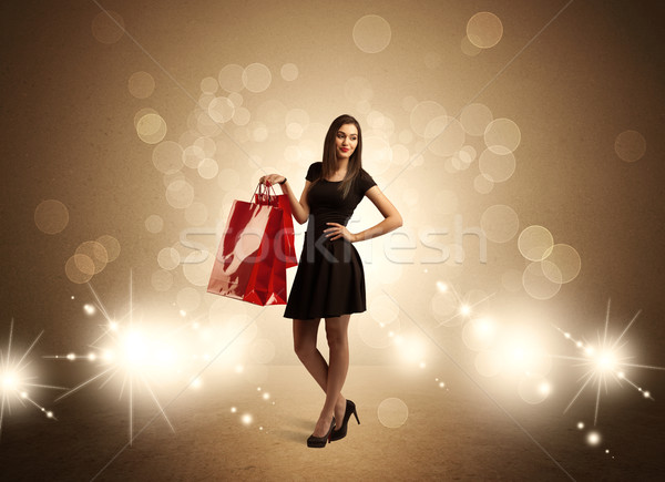 Shopping lady with bags in bright lights Stock photo © ra2studio