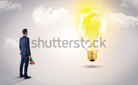 Businesswoman on rock mountain with idea bulb Stock photo © ra2studio