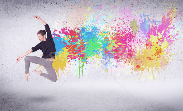 Modern street dancer jumping with colorful paint splashes Stock photo © ra2studio