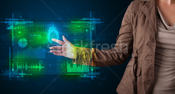 Young businesswoman pressing modern technology panel with finger Stock photo © ra2studio