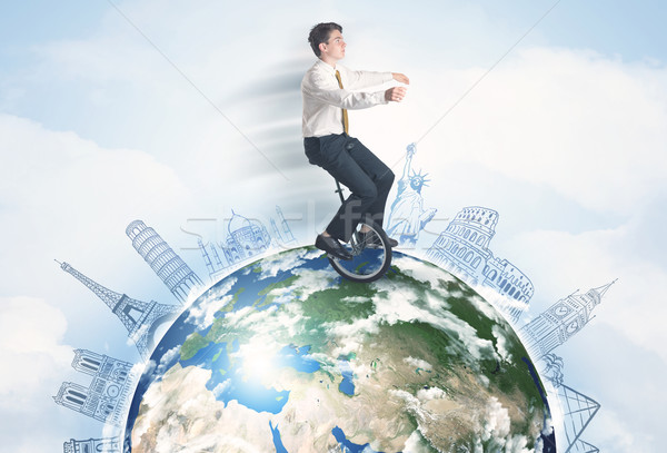 Man riding unicycle around the globe with major cities Stock photo © ra2studio
