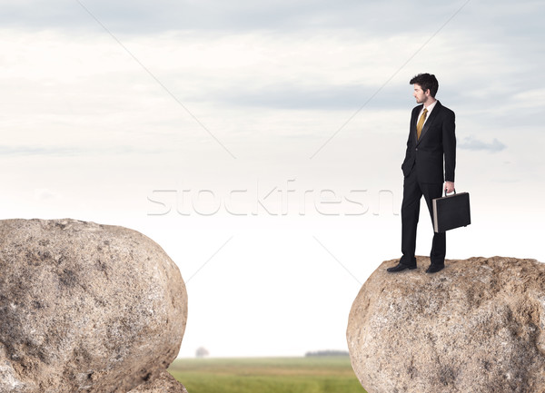 Businessman on rock mountain Stock photo © ra2studio