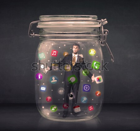 Stock photo: Businesswoman captured in a glass jar with colourful app icons c