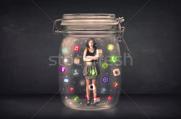 Businesswoman captured in a glass jar with colourful app icons c Stock photo © ra2studio