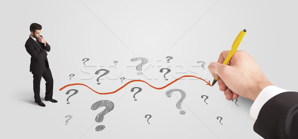 Stock photo: Business man looking at question marks and solution path