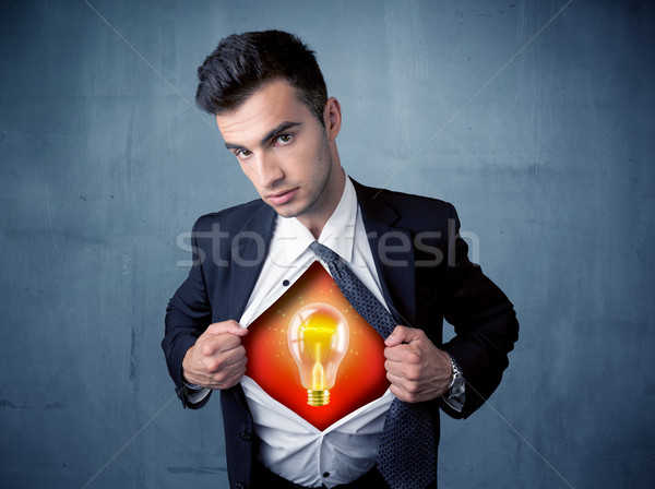 Businessman ripping off shirt and idea light bulb appears  Stock photo © ra2studio