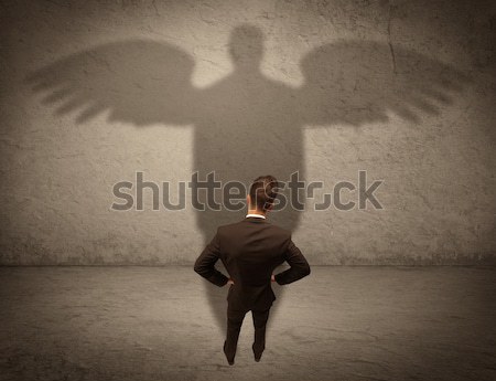 Honest salesman with angel shadow concept Stock photo © ra2studio