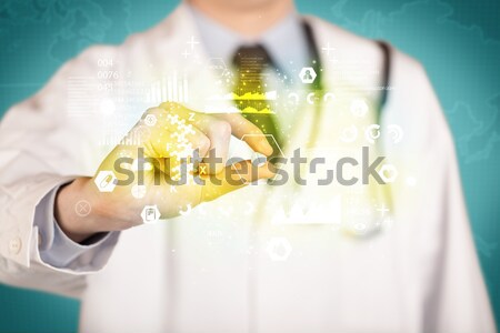 Doctor holding a pill between fingers Stock photo © ra2studio