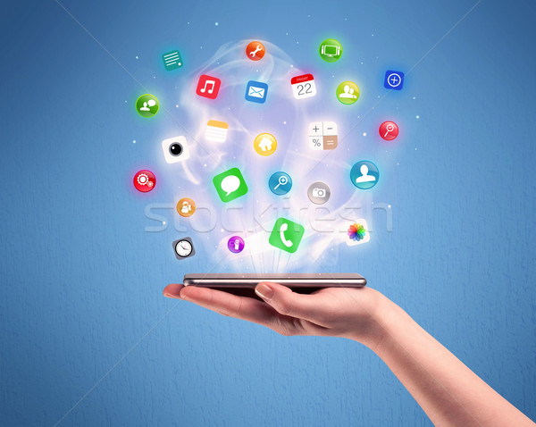 Hand holding tablet phone with app icons Stock photo © ra2studio