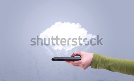 Hand holding phone with empty cloud Stock photo © ra2studio