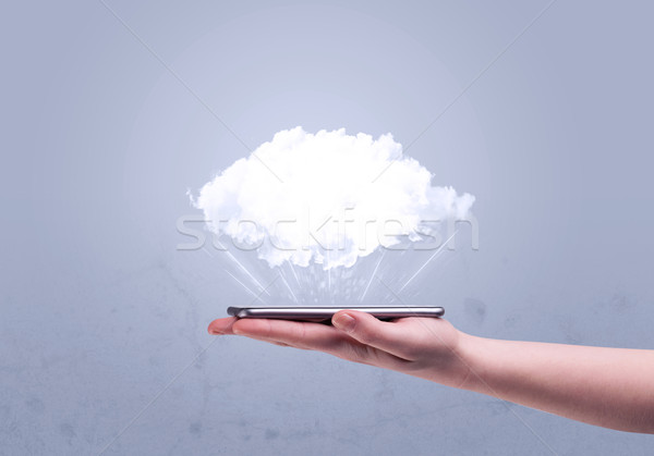 Hand holding phone with empty cloud Stock photo © ra2studio