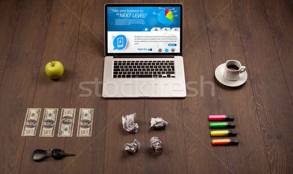 Laptop on office desk with business website on screen Stock photo © ra2studio